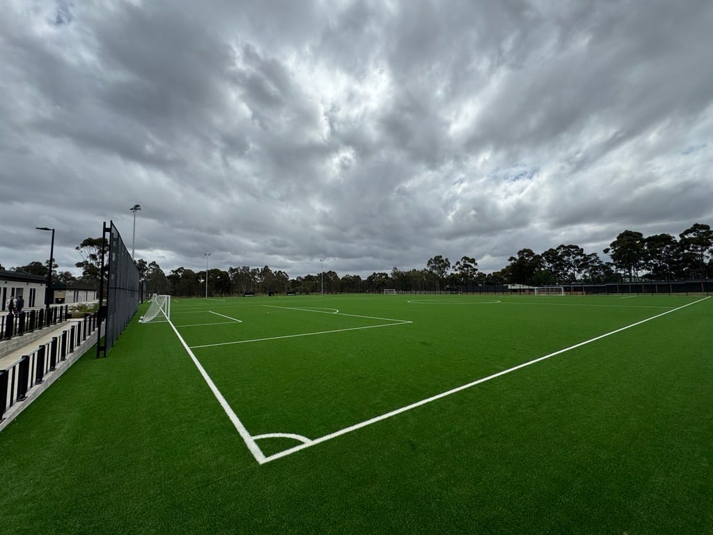 Outdoor synthetic turf soccer field with white line markings